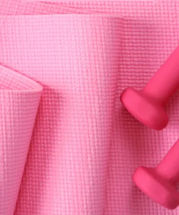 Pink yoga mat with light dumbbells for best Somatic Pilates apps.