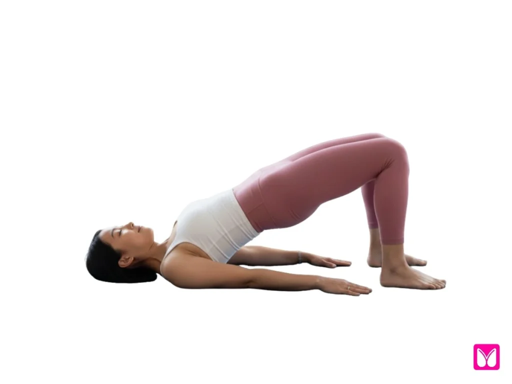 A woman demonstrating Bridge Pose (Setu Bandha Sarvangasana), one of the essential beginner yoga poses for building glute strength and improving posture.