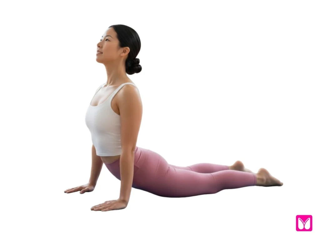 A woman performing Cobra Pose (Bhujangasana), an important beginner yoga pose for strengthening the back muscles and opening the chest.