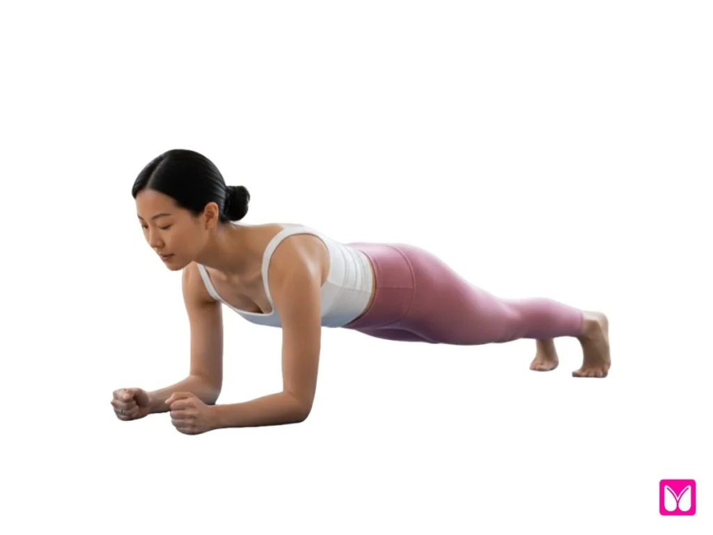 A woman holding a forearm Plank Pose (Phalakasana), demonstrating how beginner yoga poses can effectively build core stability and arm strength.